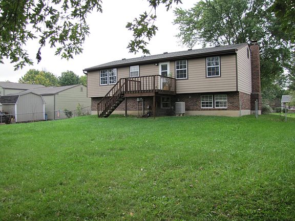 Rear view of the home, deck with back door leading into the