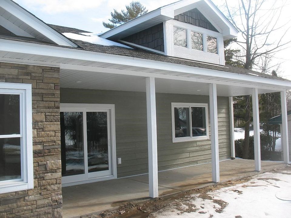 Front of home. Covered porch outside of master bedroom and dining room