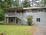 Front of home, with large deck that leads into the living room.