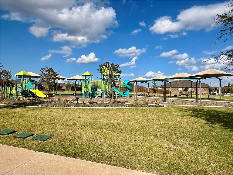 View of jungle gym featuring a lawn