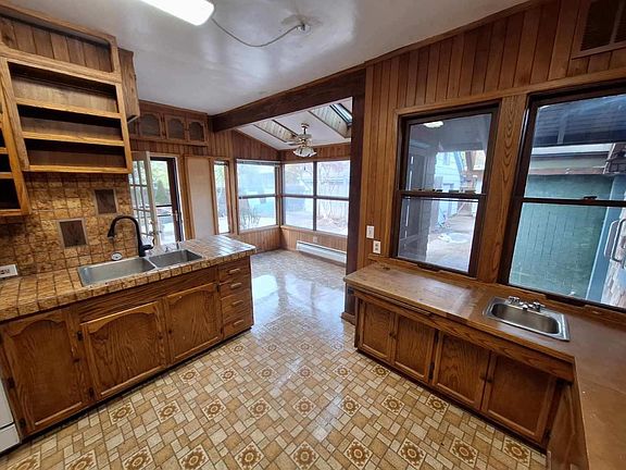 Window filled dining nook with access to covered deck.