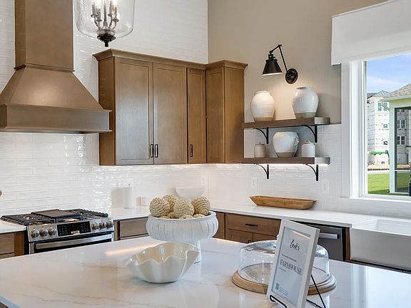Kitchen with island, pendant lighting and tile backsplash