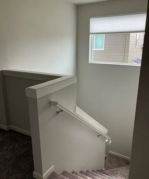 stairwell with remote control blinds on window