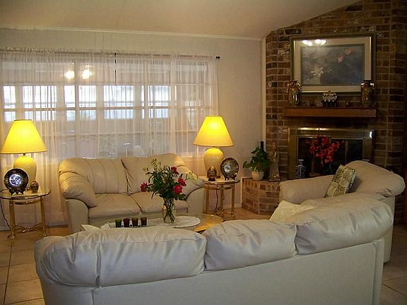 Large tiled living room with cozy gas log fireplace