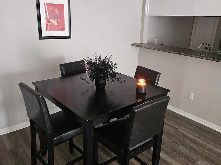 Dedicated dining area with a four-seat table, durable flooring, and a convenient pass-through counter to the kitchen.