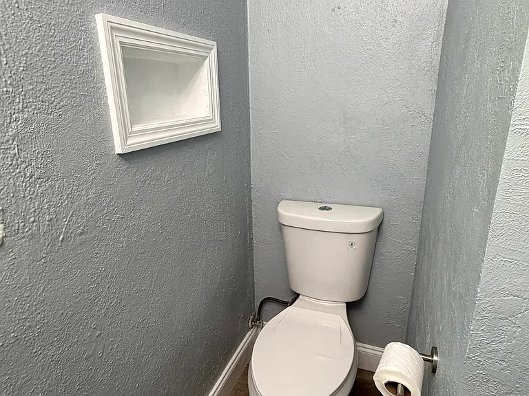 Toilet with built-in wall shelves for extra storage space