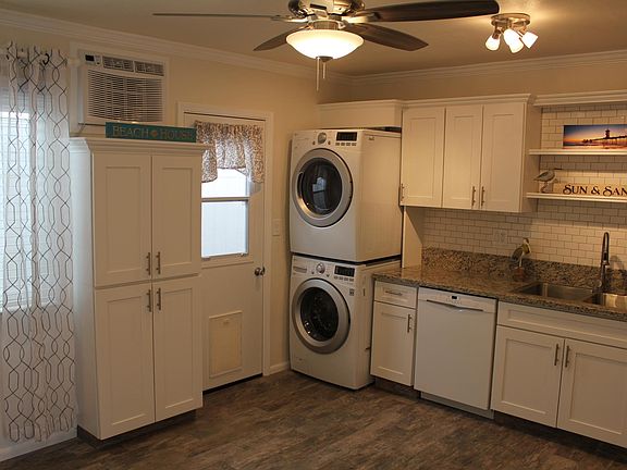 Kitchen pantry, door to side yard with built in doggie door, A/C and ceiling fan