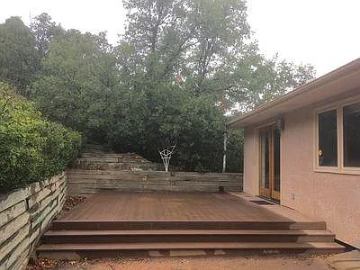 Natural hillside backyard with dining room walkout to deck