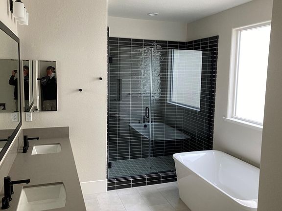 Master bath with dual sinks, shower, tub, toilet room, and walk in closet.