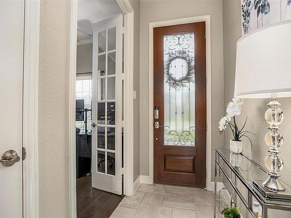 Upon entry you find a home office/study on the right with French doors, wood floors and a walk-in closet