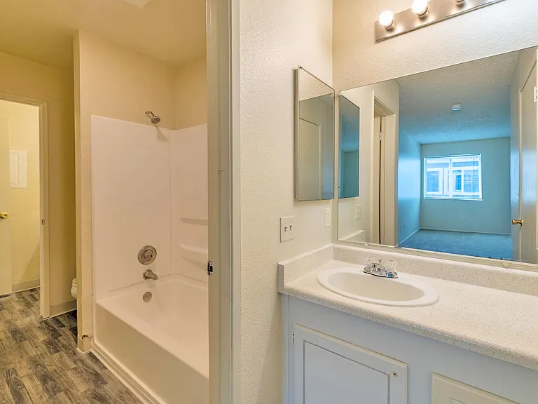 Bathroom with large tub and ample counter space.