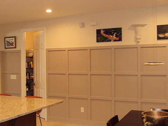 Feature wall in kitchen area with door to pantry