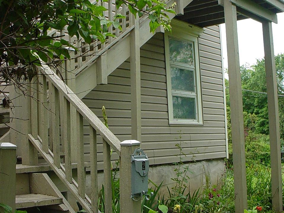 Going upstairs to the apt. Apt has it's own mailbox on the street. Small garden under the stairs. The bush is a fragrant orange bush.