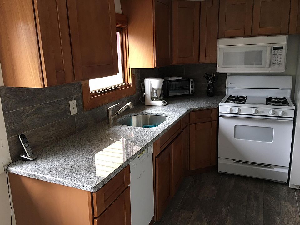 Kitchen has granite counter tops, gas stove, microwave and more