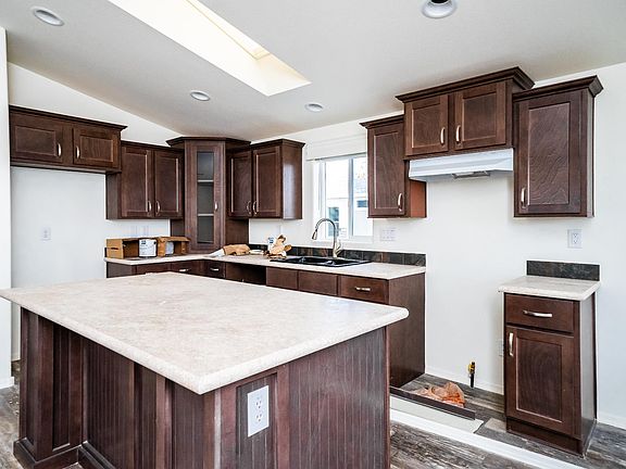 Kitchen - Solid wood cabinets, upgraded nickel hardware, title back splashes, highly upgraded stainless appliance package, center island,  country farm sink with pull out faucet, skylight, recessed lighting.