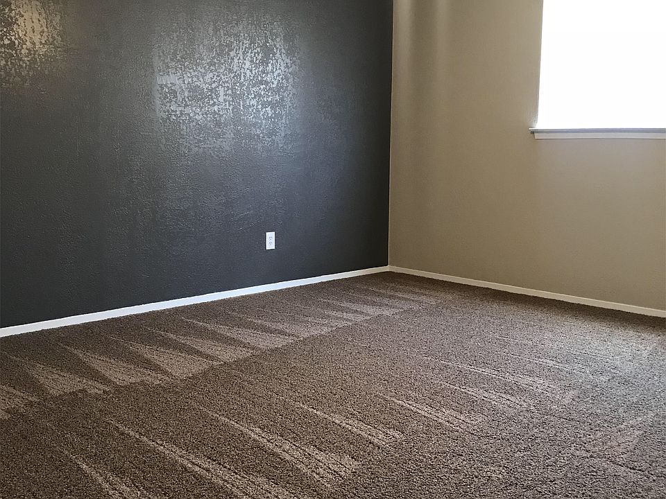 Bedroom with ceiling fan and walk in closet