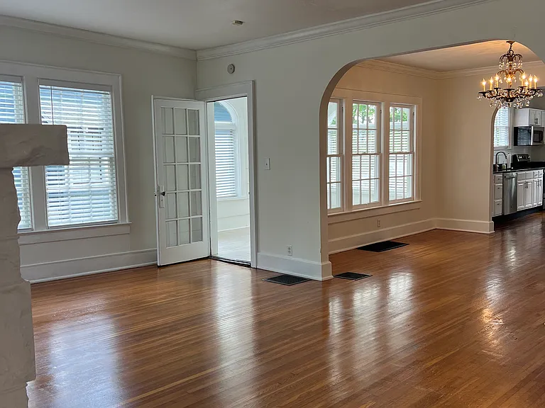 Living Room. Sun Room located to the left. Living Room leads into Dining Room and Kitchen