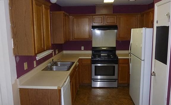 kitchen opens to living, includes refrigerator