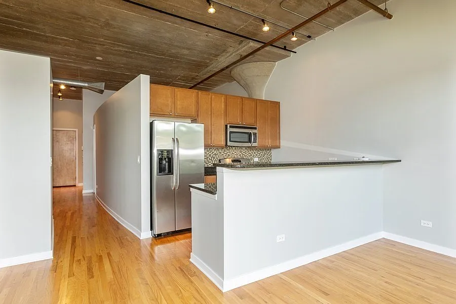 Kitchen with granite counters, stainless appliances & 42" cabinets.