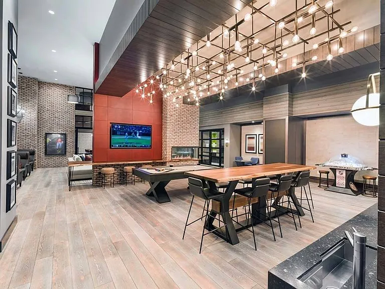 Game room featuring gathering spaces, kitchen area, HDTV and fireplace