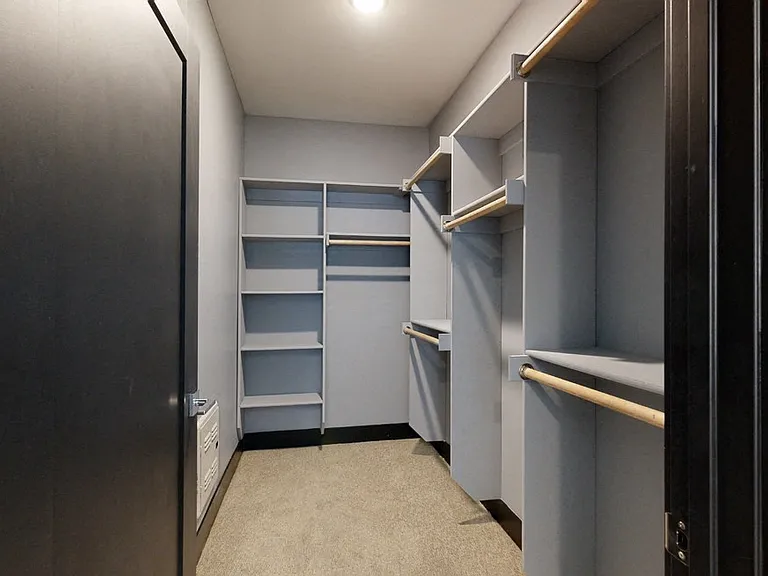 Large walk-in closets offer plenty of storage space to keep your wardrobe organized.