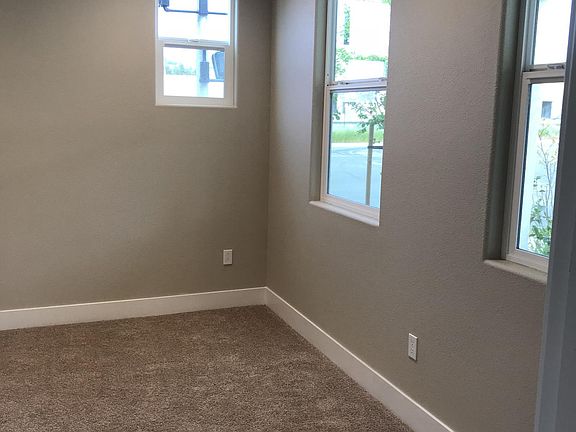 First floor bedroom with lots of windows for natural light.