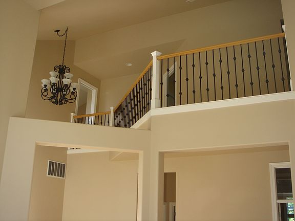 Formal Living and Dining rooms with high ceilings and tall windows