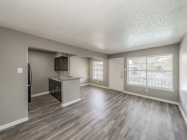 Enjoy cooking in stylish kitchens with dark cabinetry and granite-style counters at Chapel Creek Apartments.