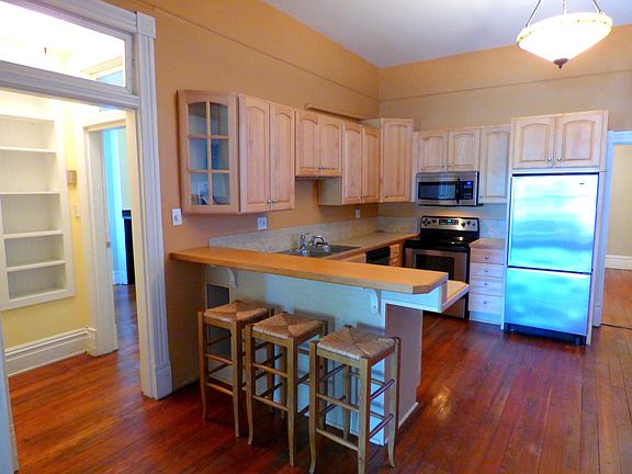 Kitchen opens to the living room with original pocket doors.