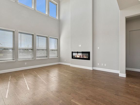 Living room in the Olympic home plan by Trophy Signature Homes - REPRESENTATIVE PHOTO