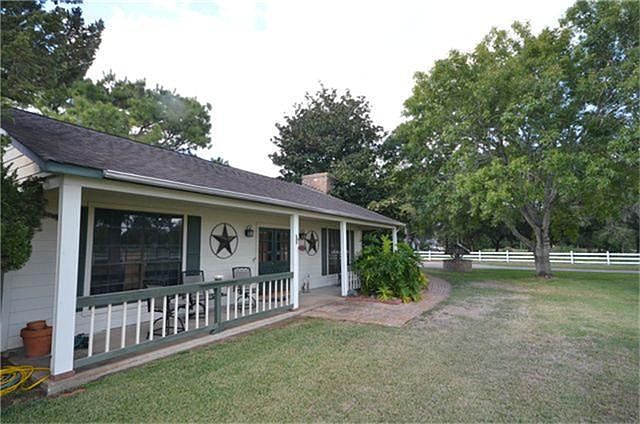 Great front and back porches with mature trees covering the property.