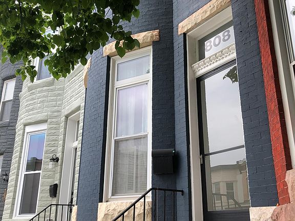 Front of home: Classic Bow front with cornice detail.