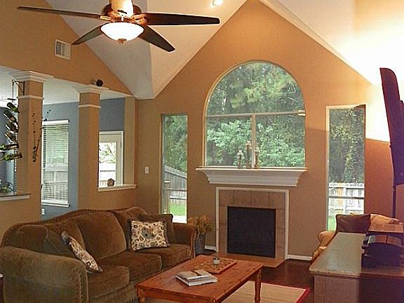 Family room features lots of windows viewing private back yard