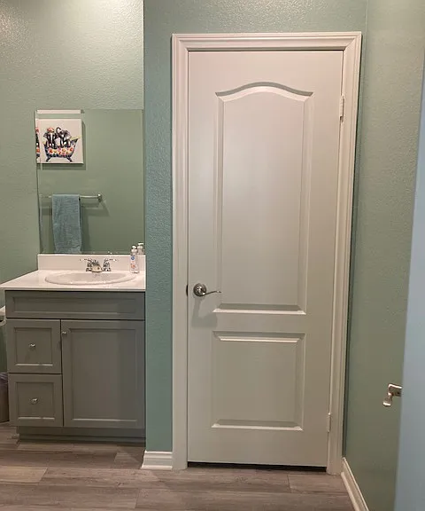 Forward shot of linen closet and sink.