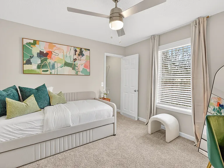 Open and airy bedroom with ceiling fan at Saddlebrook Apartments