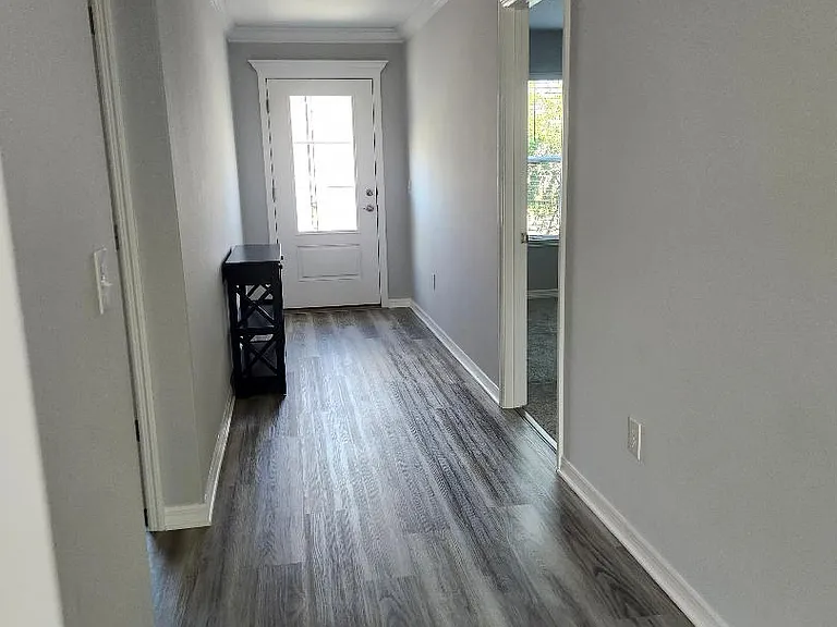 Entryway with bedroom and bathroom on left and bedroom on right