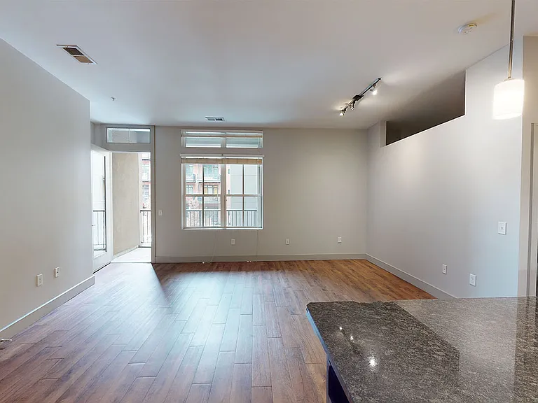 Apartment living room with wood-style flooring and patio or balcony.