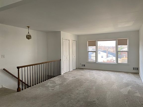 view of the living room
picture window
wall to wall carpeting