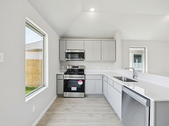 Kitchen in the Pine home plan by Trophy Signature Homes - REPRESENTATIVE PHOTO