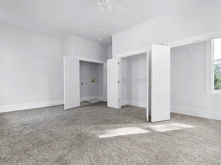 The Primary Bedroom - Level 2: washer/dryer closet, large clothing closets