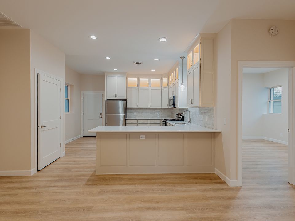 Open kitchen with dishwasher and laundry closet.