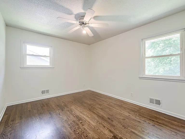 Bedroom3 (Master unfurnished) with windows overlooking the side yard and backyard
Features nice ceiling light and fan