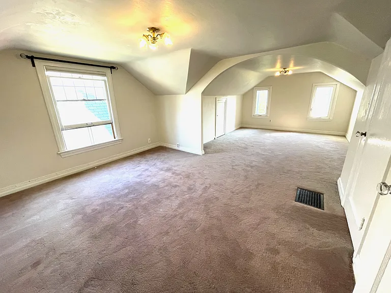 large upstairs bedroom looking into sitting area