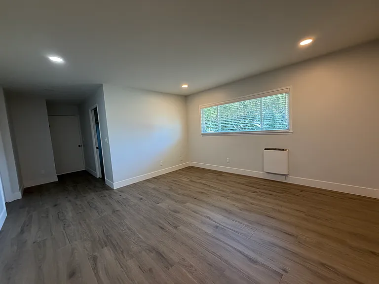 Primary bedroom with entry door and door to walk-in closet