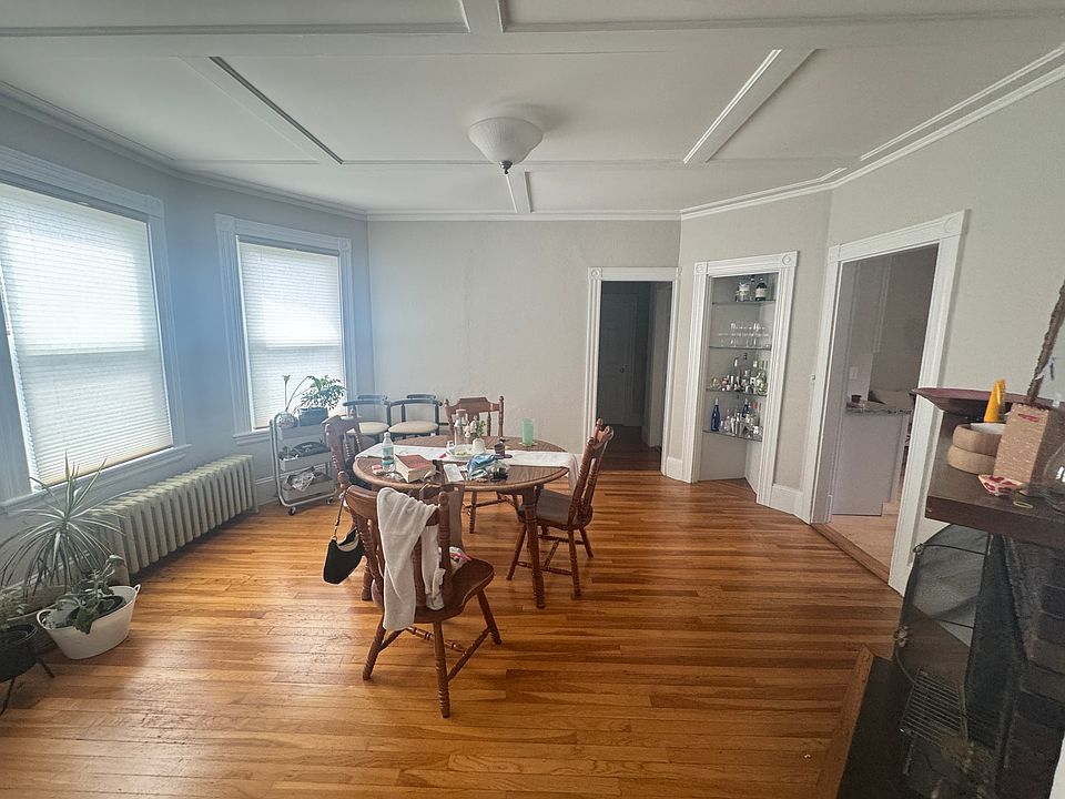 Bayed Living Room with beamed ceiling, decorative fireplace.