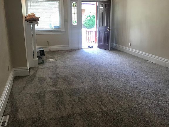 living room with stained glass windows and new carpet installed!