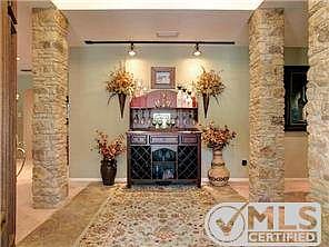 Front entry with rock columns, dining to the right and the first