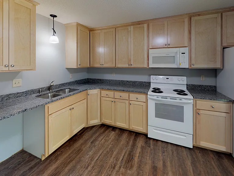 View of the kitchen featuring updated countertops and flooring