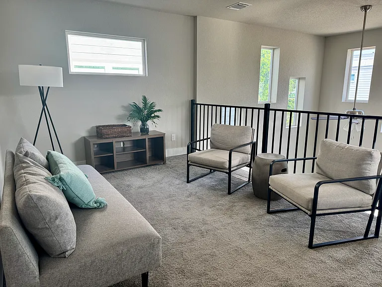Upstairs loft designed as an open, airy retreat_perfect for relaxing or unwinding in a bright, comfortable space.