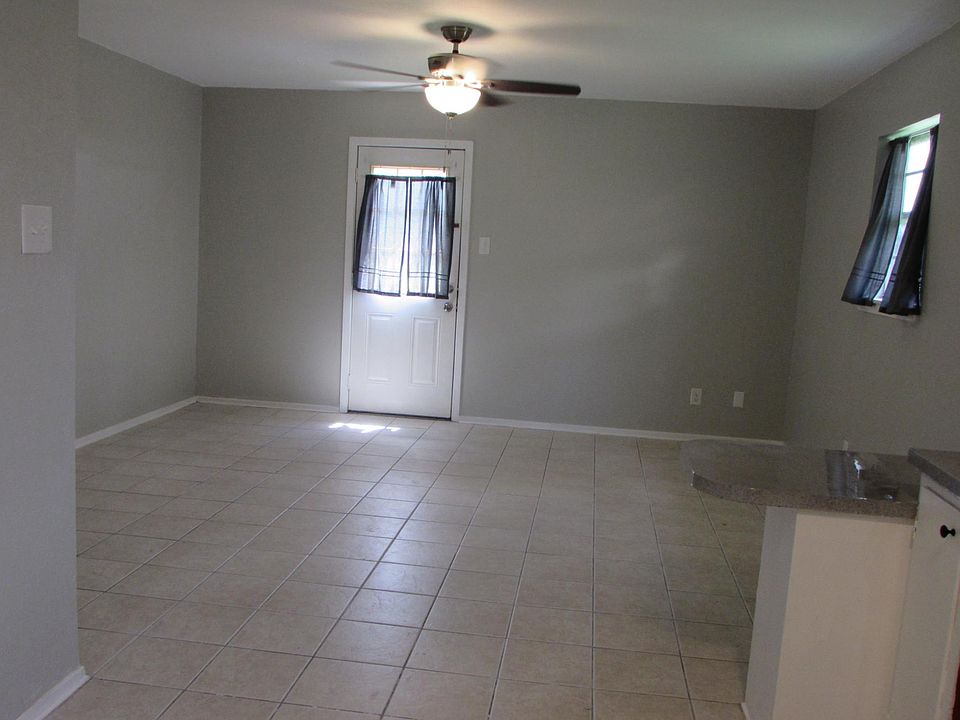 living area, photo taken from kitchen to back door